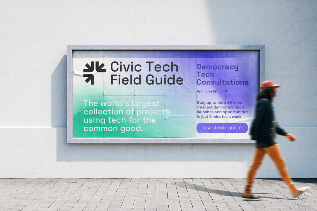 A person walks in front of a billboard promoting the Civic Tech Field Guide